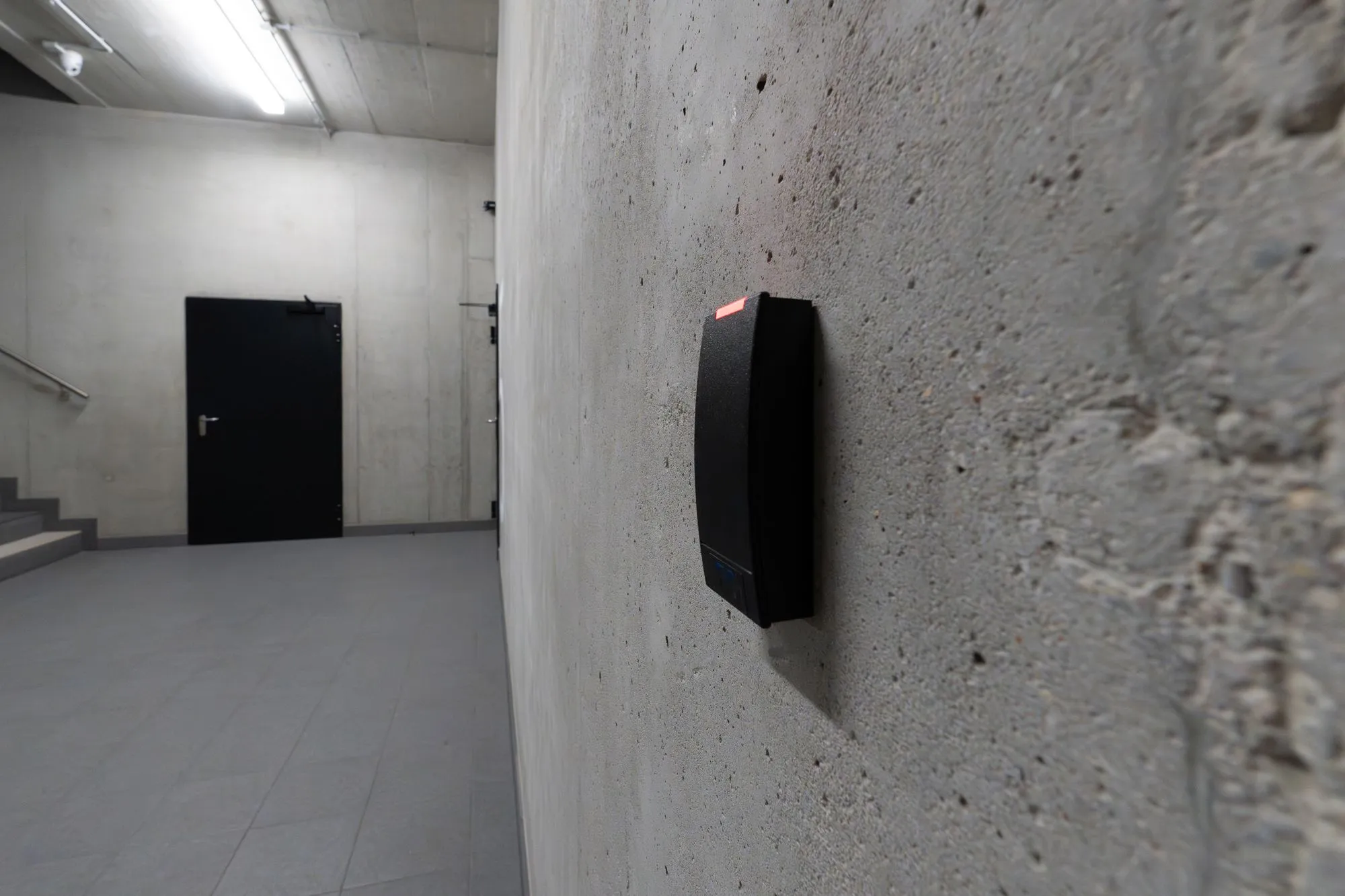 Keycard access control reader beside a commercial office door