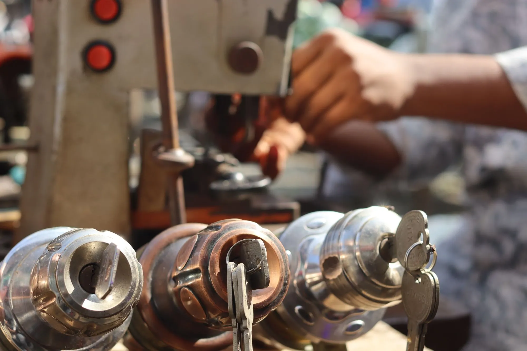 Locksmith cutting a new key on a key duplication machine